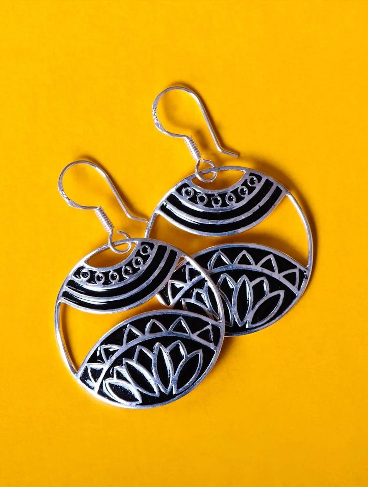 Beautiful, artistic, round dangling earrings with fine black enamel work