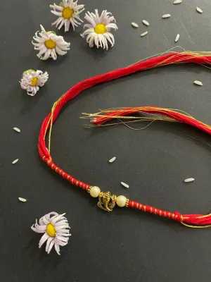 Designer Rakhi Ganesha God Designs With White Pearls Red/Golden Thread Rakhi For Raksha Bandhan